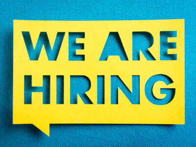 Concept of recruitment and job search. "We are hiring" yellow banner on blue textured background. Job board design, template.